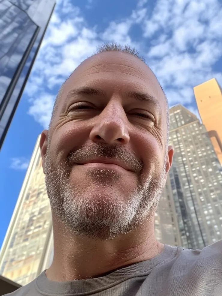 Selfie of John D. smiling outdoors, describing improvements in his prostate health routine.